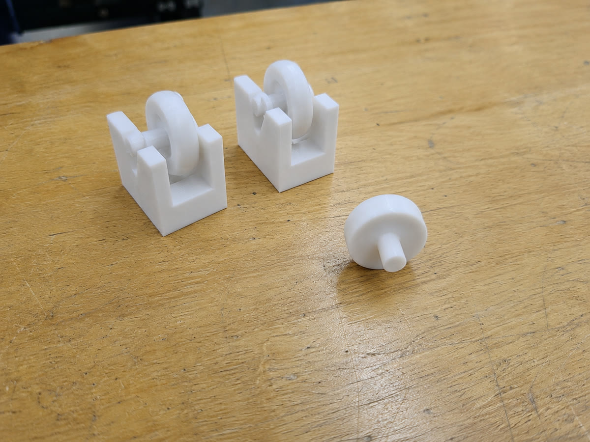 Two replacement freezer roller housings and a separate printed wheel assembly