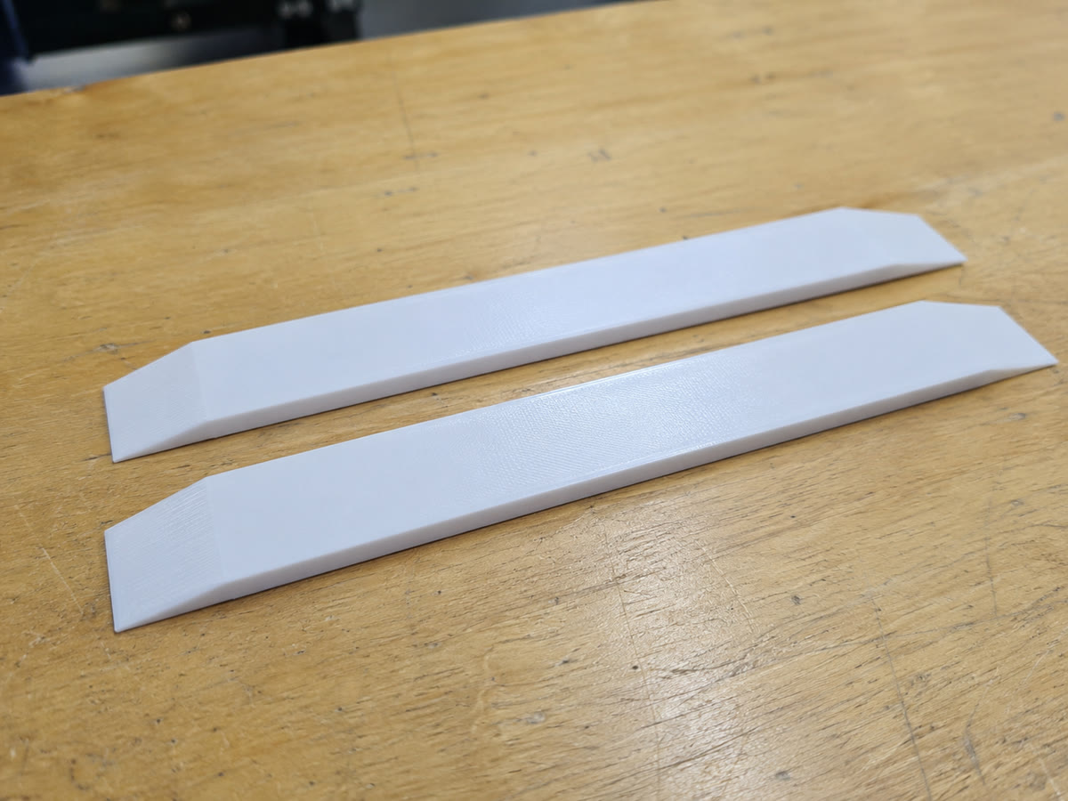 Two PETG track bridges with tapered ends for the damaged freezer rails